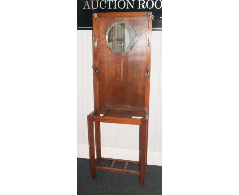 A 1920/30's Oak Hall Stand with integral mirror and 6 chrome cloth/hat hooks, glove compartment, stick and umbrella stand. St