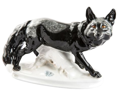 A PORCELAIN FIGURE OF A FOX, MEISSEN, PAUL WALTHUR, 20th CENTURYrealisticaly modeled black fox walking across a snowy ovoid b