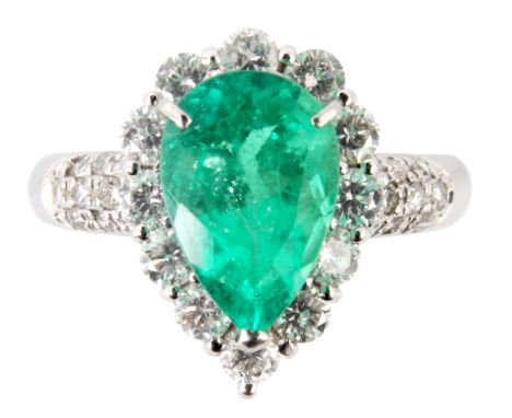 A FINE PLATINUM PEAR SHAPED EMERALD AND DIAMOND CLUSTER RING