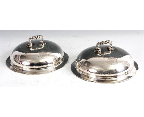 A PAIR OF WILLIAM IV CIRCULAR SILVER DISH COVERS of slightly scolloped domed form with double crested bodies and cast leaf wo