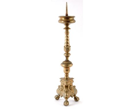 A 17TH/18TH CENTURY CONTINENTAL CAST BRASS ORNATE PRICKET CANDLESTICK OF LARGE SIZE with leaf cast knopped stem and feet cent