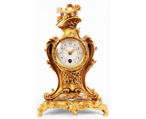 A LATE 19th CENTURY ART NOUVEAU FRENCH ORMOLU MANTEL CLOCK the decorative scrolled leaf cast case with crossed arrows finial 