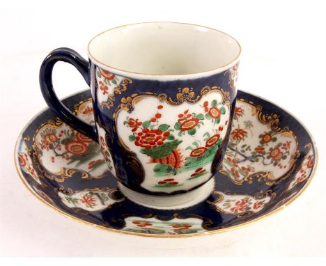 A FIRST PERIOD BLUE SCALE POLYCHROME WORCESTER CABINET CUP AND SAUCER with finely painted scrolled gilt-edged floral and land