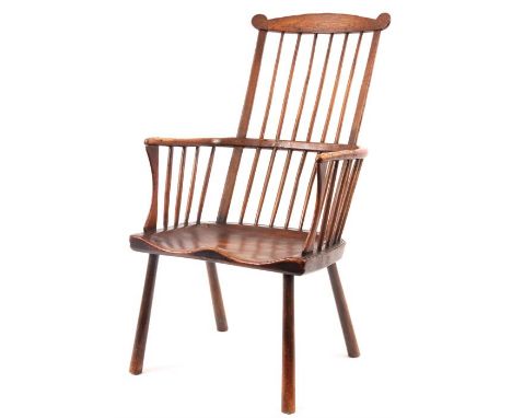 A LARGE MID 18TH CENTURY ASH AND ELM COMB-BACK WINDSOR ARMCHAIR having a shaped top rail back with stick supports, hooped arm