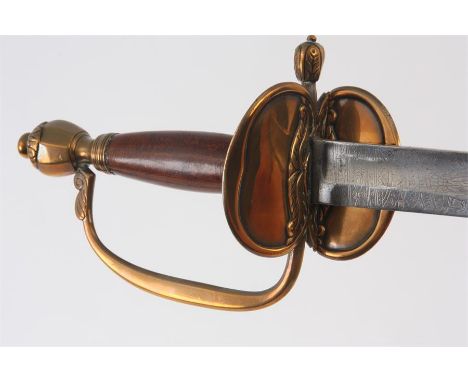 A 1976 PATTERN INFANTRY OFFICERS SWORD having hinged folding brass guard and wooden handle, engraved steel blade with black l
