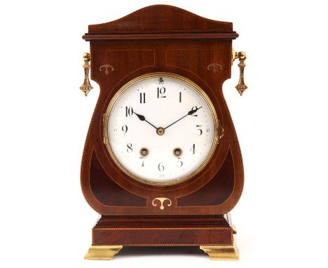 AN EDWARDIAN ART NOUVEAU STYLE TULIP-SHAPED INLAID MAHOGANY MANTEL CLOCK with shaped pediment, brass drop side handles and og