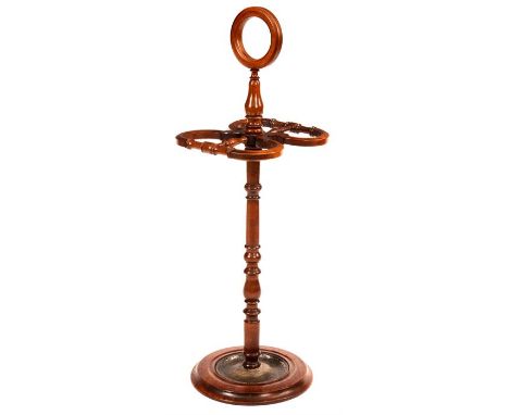 A LATE 19th CENTURY DOUBLE SIDED STICK/UMBRELLA STAND with circular tray base, turned stem and ring handle 92cm high