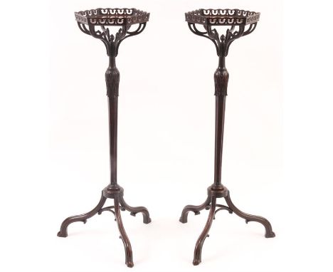 A PAIR OF 19TH CENTURY CHIPPENDALE STYLE MAHOGANY TORCHERES with hexagonal figured pierced edge tops above leaf carved taperi
