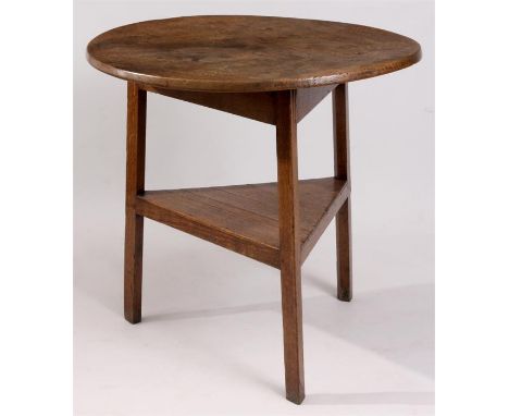 A GEORGE III HONEY COLOURED FIGURED OAK CRICKET TABLE with a one piece top above a triangular base joined by a raised under s