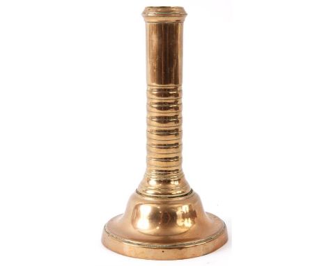 AN UNUSUAL 18TH CENTURY BELL METAL CANDLESTICK with a ribbed cylindrical stem on a domed footed base 16.5cm high