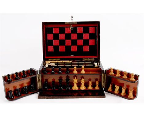 A VICTORIAN ROSEWOOD GAMES COMPENDIUM BOX with hinged lid and front revealing a boxwood and ebony chess set, cribbage board, 