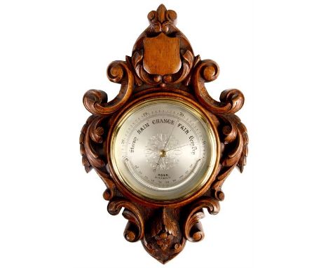 ROSS, LONDON A LATE 19TH CENTURY OAK ANEROID BAROMETER/THERMOMETER with honey coloured scrolled floral carved surround. The 5