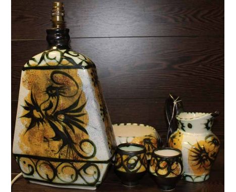 GROUP OF NEWLYN CORNWALL CELTIC POTTERY
all with yellow and green stylised bird design, incluing a lamp, bowl, jug and two be