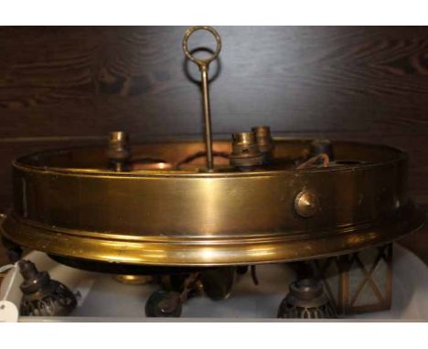 TWO EARLY 20TH CENTURY BRASS THREE SHADE LIGHT FITTINGS
both with circular bodies and three shades within; together with two 