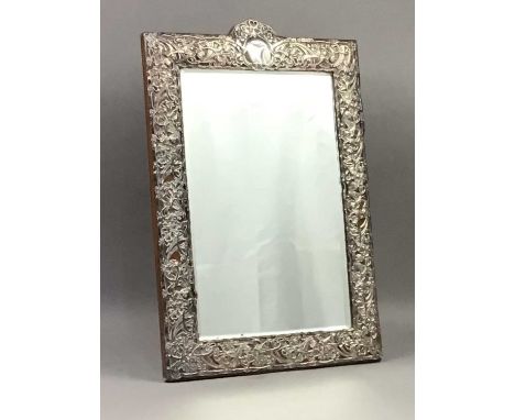 ART NOUVEAU CONTINENTAL SILVER MOUNTED DRESSING TABLE MIRROR,apparently unmarked, pierced and embossed with stylised scrollin