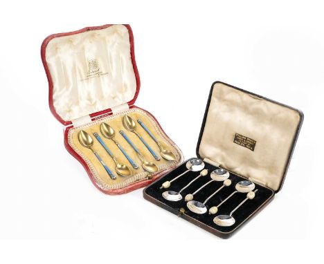 TWO SETS OF ENAMELLED SILVER COFFEE SPOONS,the first a Norwegian silver gilt and guilloche enamel set, marked 'TH' with Chest