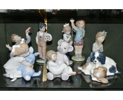 EIGHT NAO FIGURES OF CHILDREN AND PUPPIES, comprising a girl with toy rabbit (repaired and broken around neck), a girl asleep