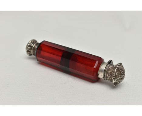 A LATE VICTORIAN DOUBLE ENDED RUBY GLASS SCENT FLASK WITH WHITE METAL MOUNTS, the flask of decagonal form with hinged and scr