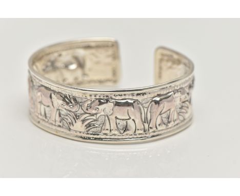 A SILVER CUFF BANGLE, depicting a row of embossed elephants, hallmarked Birmingham, approximate gross weight 25.2 grams