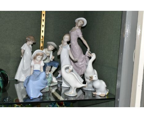 SEVEN NAO FIGURES AND A LLADRO DUCK, the tallest, a female figure in a flowing dress, measures 28.5cm, together with a shephe