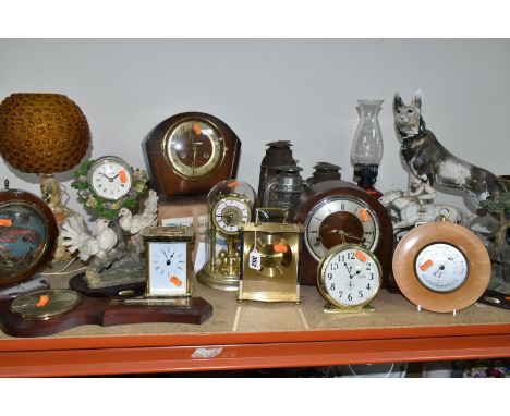 A GROUP OF CLOCKS AND LAMPS, comprising two nautical themed 1960's lamps, three hurricane lamps, two barometers, a boxed 'And