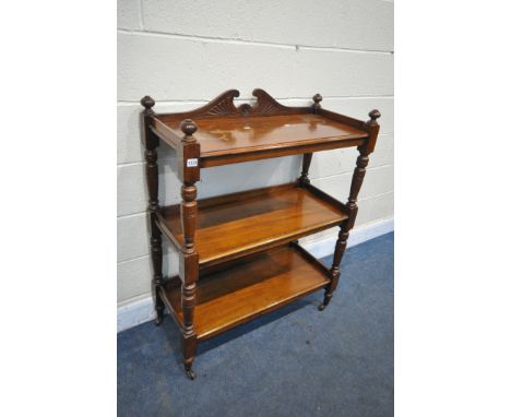 AN EDWARDIAN WALNUT THREE TIER BUFFET, united by turned supports, on ceramic casters, width 87cm x depth 39cm x height 112cm 