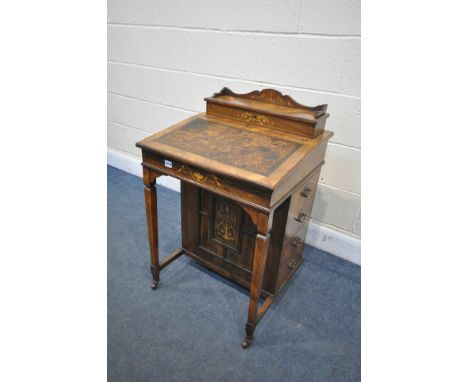 A LATE 19TH CENTURY ROSEWOOD AND MARQUETRY INLAID DAVENPORT, with a hinged top enclosing divisions, behind a leather writing 