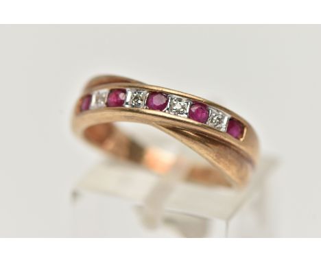 A 9CT GOLD RUBY AND DIAMOND HALF ETERNITY RING, set with a row of alternating rubies and single cut diamonds, cross over styl