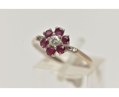 A YELLOW METAL, DIAMOND AND RUBY CLUSTER RING, flower cluster set with a central round brilliant cut diamond, estimated diamo