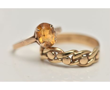 A 9CT GOLD CITRINE RING AND A YELLOW METAL RING, the first a yellow gold ring set with an oval cut citrine, hallmarked 9ct Ed