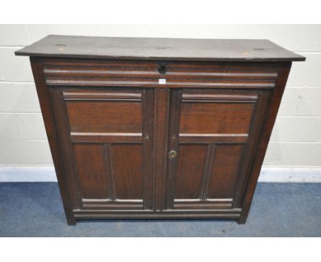 A PART 17TH CENTURY OAK WAINSCOT CUPBOARD, with a half hinged compartment to the top, double panelled cupboard doors, enclosi