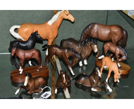 A GROUP OF BESWICK AND ROYAL DOULTON HORSES, comprising a Palomino Swish Tail Horse no 1182, a Shire Foal - Lying 2460, Black