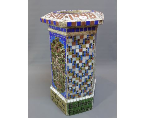 A plaster and mosaic stick stand/planter.