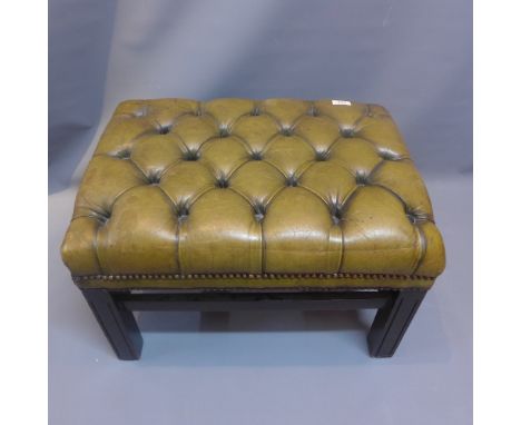 A green leather button back footstool 