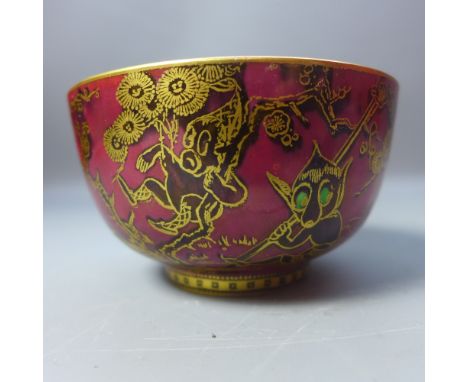 A Wedgewood Fairyland lustre bowl, black elfs and goblins with gold gilt on ruby red ground. The inside depicting a girl on l