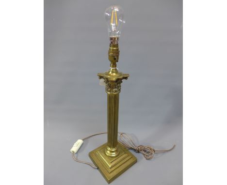 An early 20th Century brass Corinthium column lamp on stepped base. H-47cm 