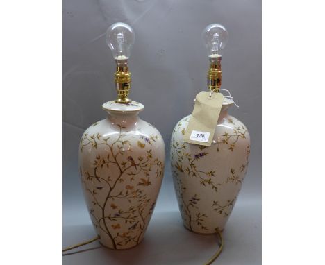 A pair of contemporary crackle glazed ceramic table lamps decorated with flora and fauna.