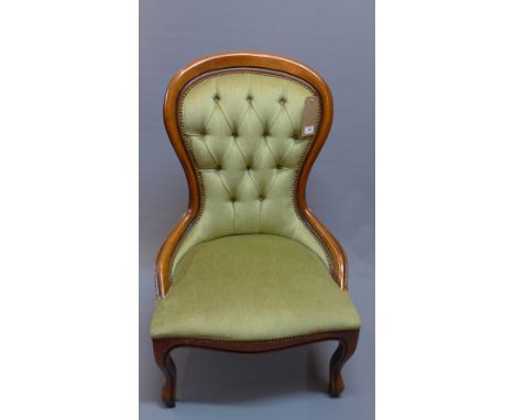 A 20th Century mahogany spoon back chair with green button back velour upholstery and raised on cabriole legs