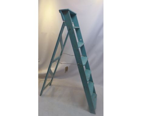 A blue painted pine step ladder.