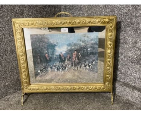 A brass fire screen with hunting print to centre