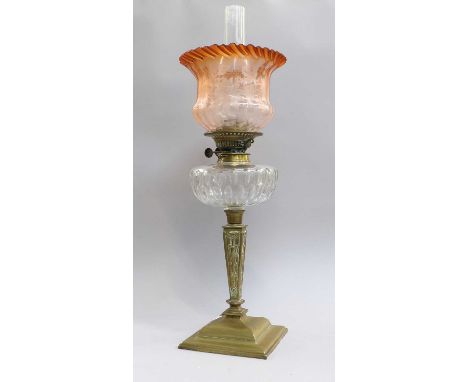 A Late Victorian/Edwardian Brass Oil Lamp, with cut glass reservoir and apricot glass shadeSome minor dents to the foot, othe