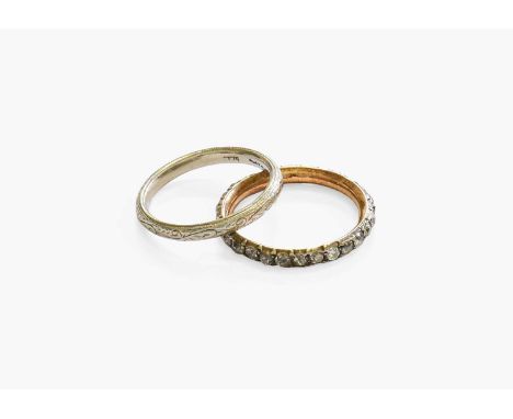 A Band Ring, stamped 'PLATINUM', finger size K; and A Diamond Eternity Ring, the old cut diamonds in white claw settings, fin