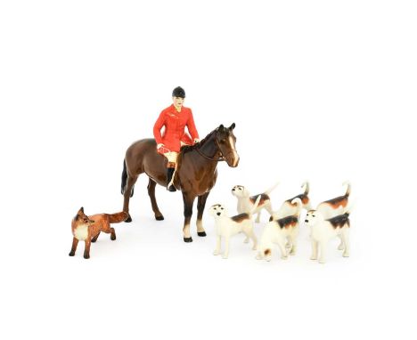 Beswick Hunting Group Comprising: Huntsman (Standing), Style Two, model No. 1501, brown gloss, a Fox and six Fox Hounds (8)