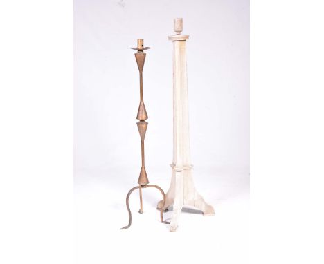 An early 20th Century Art Nouveau bronzed metal candle holder and a Gothic candle standThe bronzed candle holder on three dow