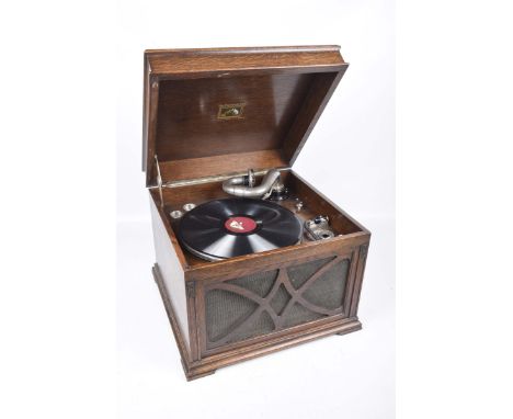 An oak cased "His Masters Voice" gramophoneWith a hinged caddy top above a front fretwork grille, raised on bracket feet, 43c