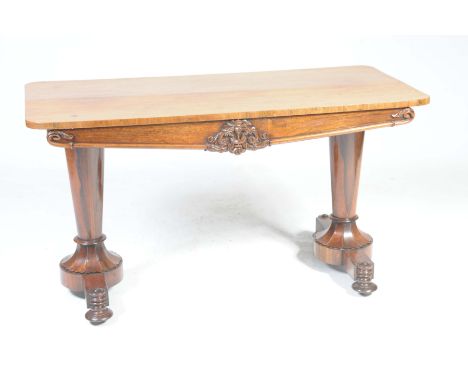 A William IV rosewood centre tableThe rectangular top with rounded corners above a frieze centred with a moulded and carved s