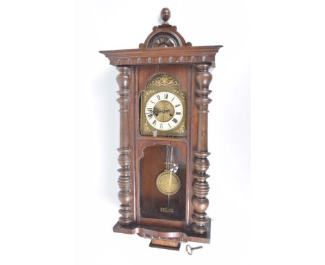 A Vienna wall clock, early 20th CenturyThe 15cm cream enamel dial with Roman numerals, gilt spandrels, elaborate pendulum, he