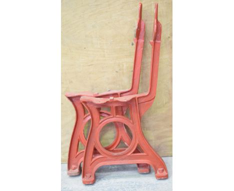 A pair of painted cast iron railway bench supportsEach end cast with a circular channelled aperture and raised on a spreading