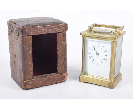 A brass framed carriage clock, late 19th early 20th CenturyBrass case with bevelled glass panels, complete red Morocco travel