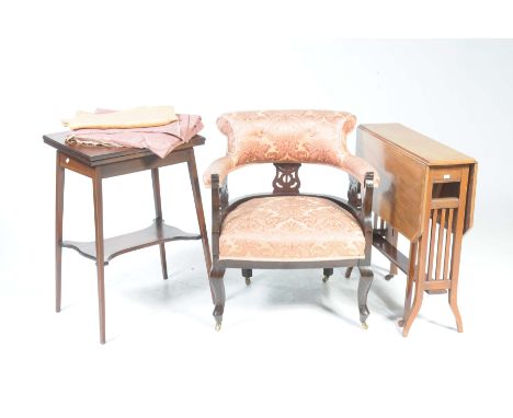 An Edwardian tub chair, Sutherland table and games tableThe tub chair with a padded rail supported on three openwork splats, 